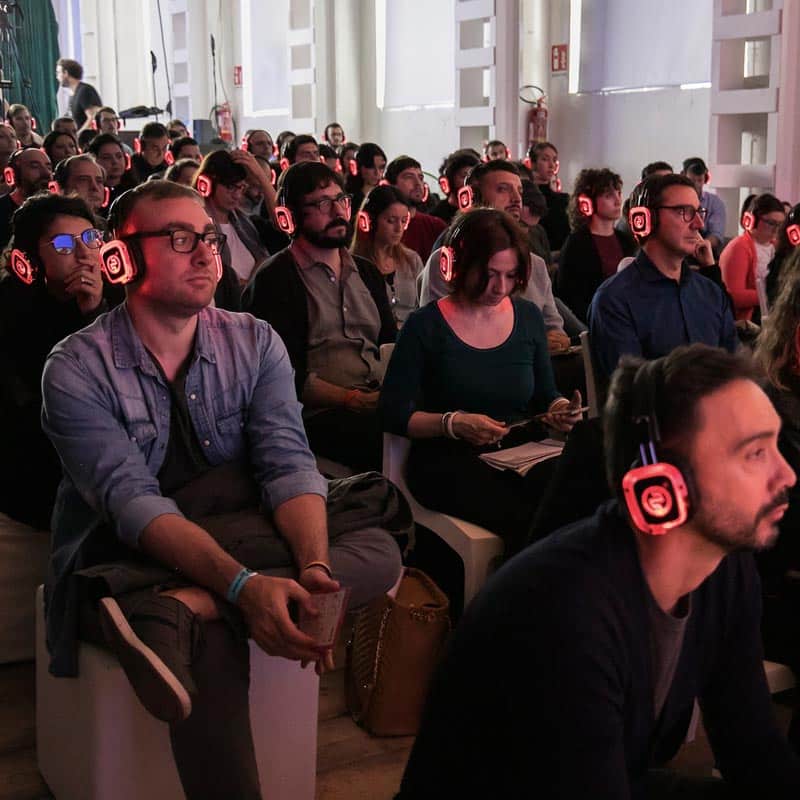Meeting Lab Silentsystem Seated audience wearing red LED wireless headphones at a meeting