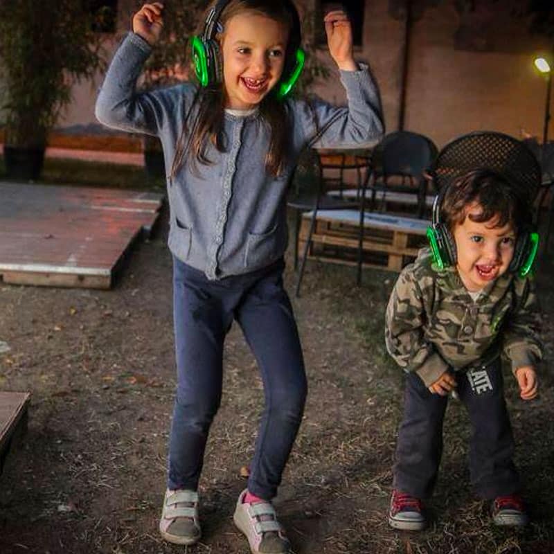 babydance Kids dancing with green wireless headphones at a party